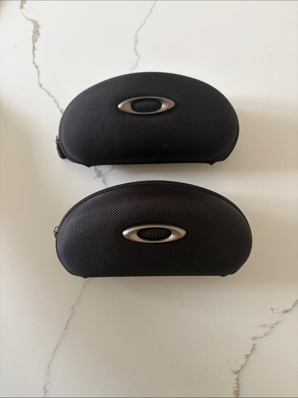 Two Oakley black soft shell case glass or safety glass holder
